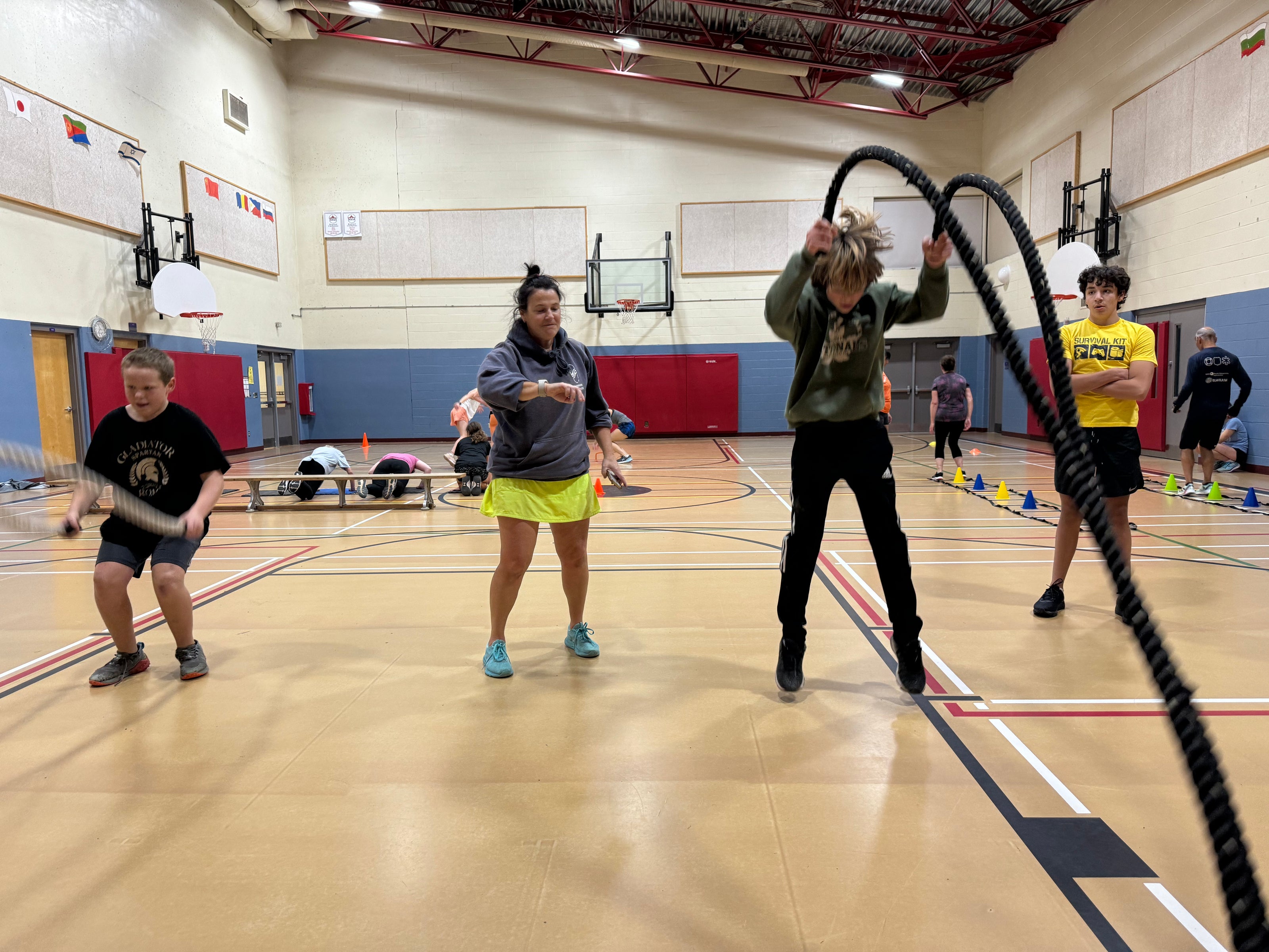 Athletes do the rope slam in a school hyym as part of their winter training.