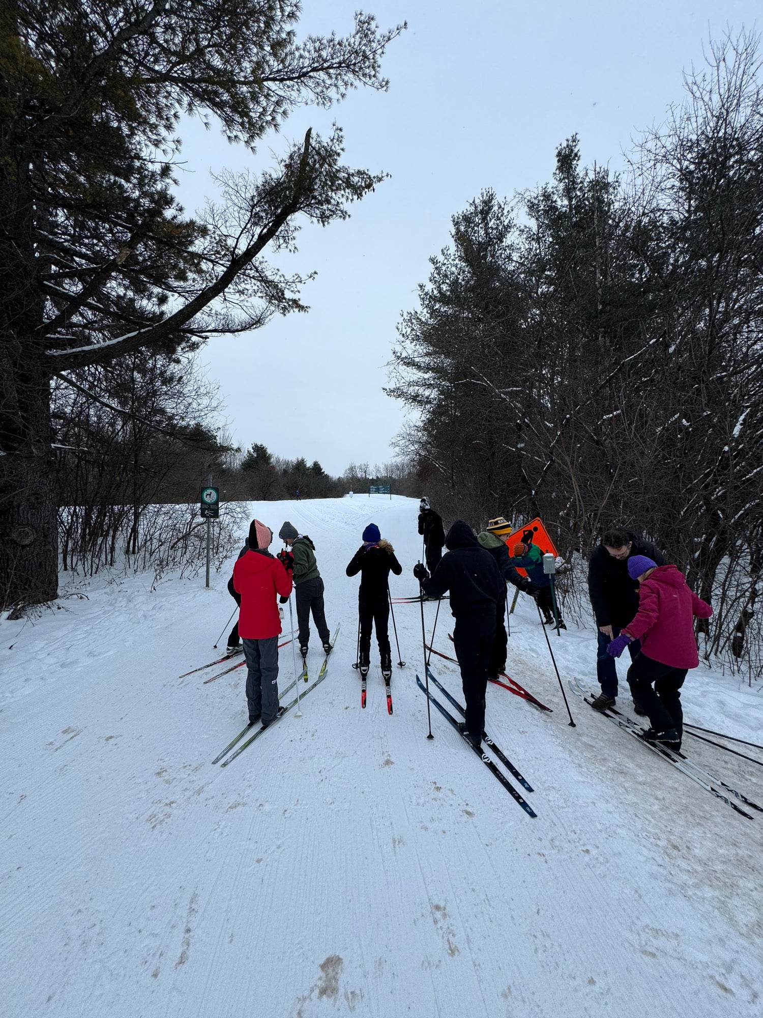 Athletes get ready for a XC ski practice at Gatineau Park on an overcast morning.